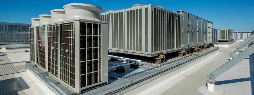 Commercial rooftop HVAC units installed on a building, showcasing large-scale industrial air conditioning systems. The image highlights energy-efficient climate control solutions and professional HVAC infrastructure for commercial properties.